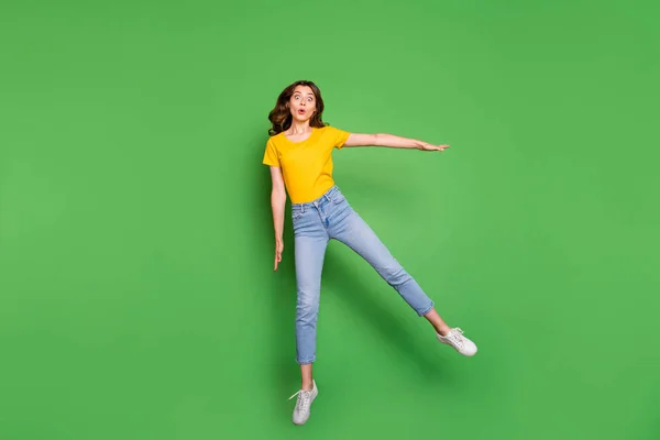 Full length body size view of nice attractive lovely childish slim fit thin cheerful wavy-haired girl having fun jumping fooling isolated on bright vivid shine vibrant green color background — Stok fotoğraf