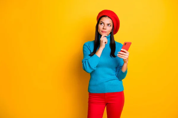 Portrait of nice attractive lovely pretty pensive minded serious girl making decision holding in hands cell modern public post smm isolated over bright vivid shine vibrant yellow color background — Stock Photo, Image