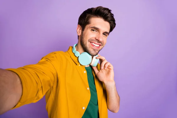 Self photo of stylish white cheerful man taking selfie expressing pleasure on face smiling toothily isolated pastel color violet background — Stock Photo, Image