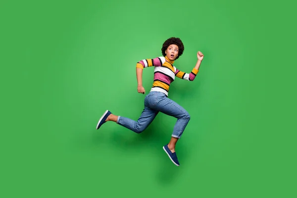 Full body photo of frustrated afro american girl loo copyspace see terrible monster jump run wear denim jeans beautiful hipster clothes isolated over green color background — Stock fotografie