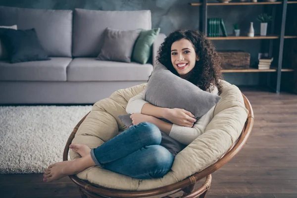 Portrait of her she nice attractive lovely charming cute winsome cheerful cheery wavy-haired girl sitting in armchair hugging pillow in modern loft industrial brick style interior living-room — 스톡 사진