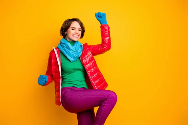 Photo of pretty funny lady ecstatic mood rejoicing celebrating success wear casual red overcoat blue scarf gloves green turtleneck pants isolated yellow color background — Stock Photo, Image