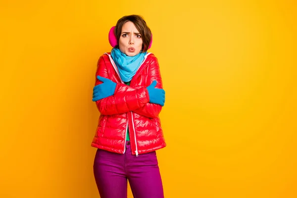 Photo of pretty traveler lady model not expect frosty weather trip shaking wear stylish casual short red overcoat blue scarf gloves ear covers pants isolated yellow color background — 图库照片