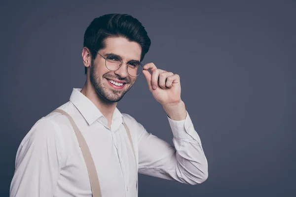 Close-up profile side view portrait of nice attractive professional cheerful cheery brunet guy expert finance real estate agent broker employer touching specs isolated on grey pastel color background — Stock Photo, Image