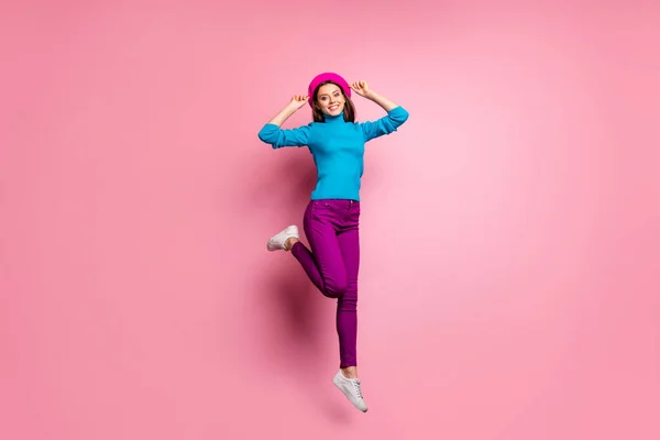Full body photo of charming cheerful girl jump enjoy weekends touch her modern french beret feel content emotions wear stylish clothes isolated pastel color background — Stock Photo, Image