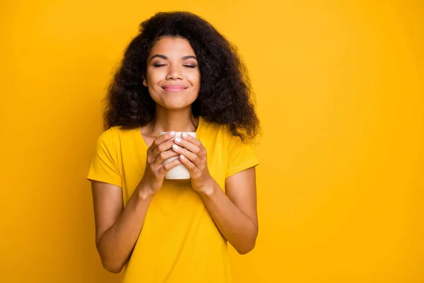 Close-up portrait of her she nice attractive lovely calm dreamy cheerful wavy-haired girl drinking sweet cacao harmony isolated over bright vivid shine vibrant yellow color background — Stock Photo, Image