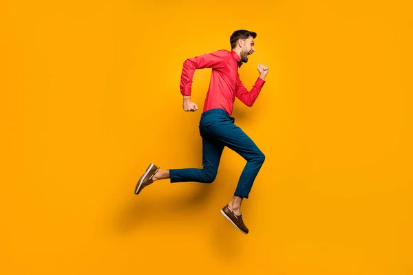 Full length profile photo of crazy funny guy jumping high up rushing black friday shopping wear trendy red shirt bow tie pants shoes outfit isolated yellow color background — Stockfoto