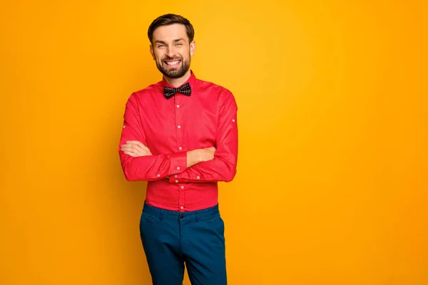 Photo of attractive macho business guy arms crossed friendly person reliable worker wear stylish red shirt with black bow tie blue trousers isolated yellow color background — Stockfoto