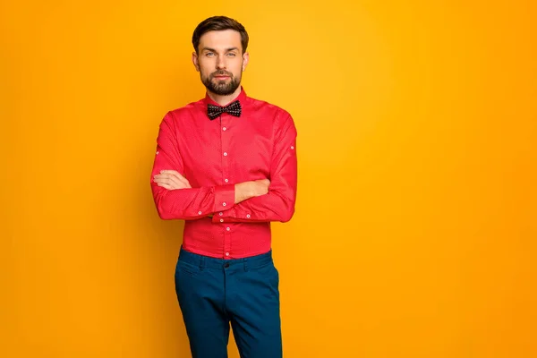 Photo of attractive macho business guy arms crossed self-confident person worker wear stylish red shirt with black bow tie blue trousers isolated yellow color background — Stock Photo, Image