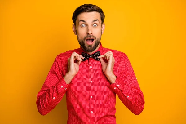 Photo of funny macho guy affectionate good mood enjoy unexpected surprise clothing new black bow tie open mouth wear stylish red shirt isolated yellow color background — 图库照片
