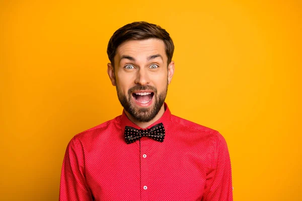 Wauw. Foto van grappige macho man goed humeurig vriendelijk glimlachen genieten van onverwachte verrassing open mond dragen stijlvolle rode shirt met zwarte strik geïsoleerde gele kleur achtergrond — Stockfoto