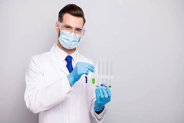 Portrait of his he nice attractive smart clever doc surgeon holding in hands bulbs making virus reaction analysis lab creating new drug remedy isolated on light white gray pastel color background — Stock Photo, Image