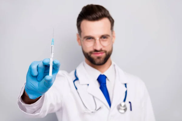 Close-up blurred portrait of his he nice attractive experienced qualified bearded doc paramedic preparing showing prick drug anti virus isolated on light white gray pastel color background — 스톡 사진