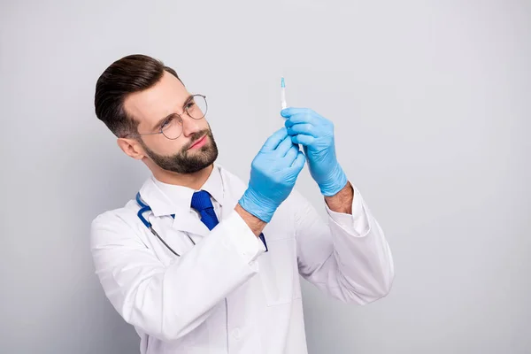 Close-up portrait of his he nice attractive smart clever focused experienced qualified bearded doc paramedic preparing prick drug pharmacy isolated on light white gray pastel color background — 스톡 사진