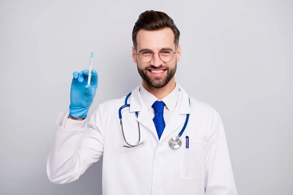Close-up portrait of his he nice attractive cheerful cheery experienced confident qualified bearded doc paramedic preparing prick vaccine isolated on light white gray pastel color background — 스톡 사진