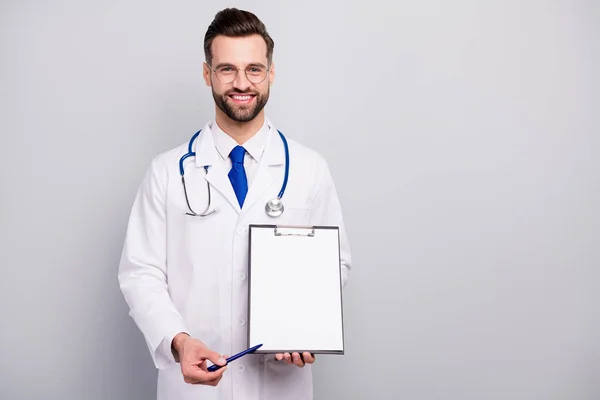 Portrait of his he nice attractive smart clever cheerful cheery bearded doc showing place for signature paper document agreement service terms isolated on light white gray pastel color background — 스톡 사진