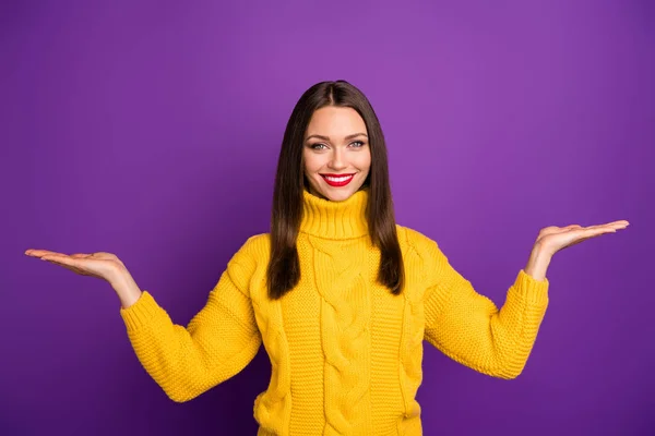 Photo of cheerful positive cute attractive woman holding two things with hands smile toothy holding empty space isolated vivid color background purple — 스톡 사진