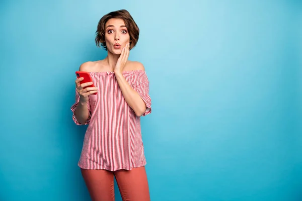 Portrait of her she nice attractive lovely winsome pretty cute amazed girl using digital device browsing smm news isolated over bright vivid shine vibrant blue color background — ストック写真