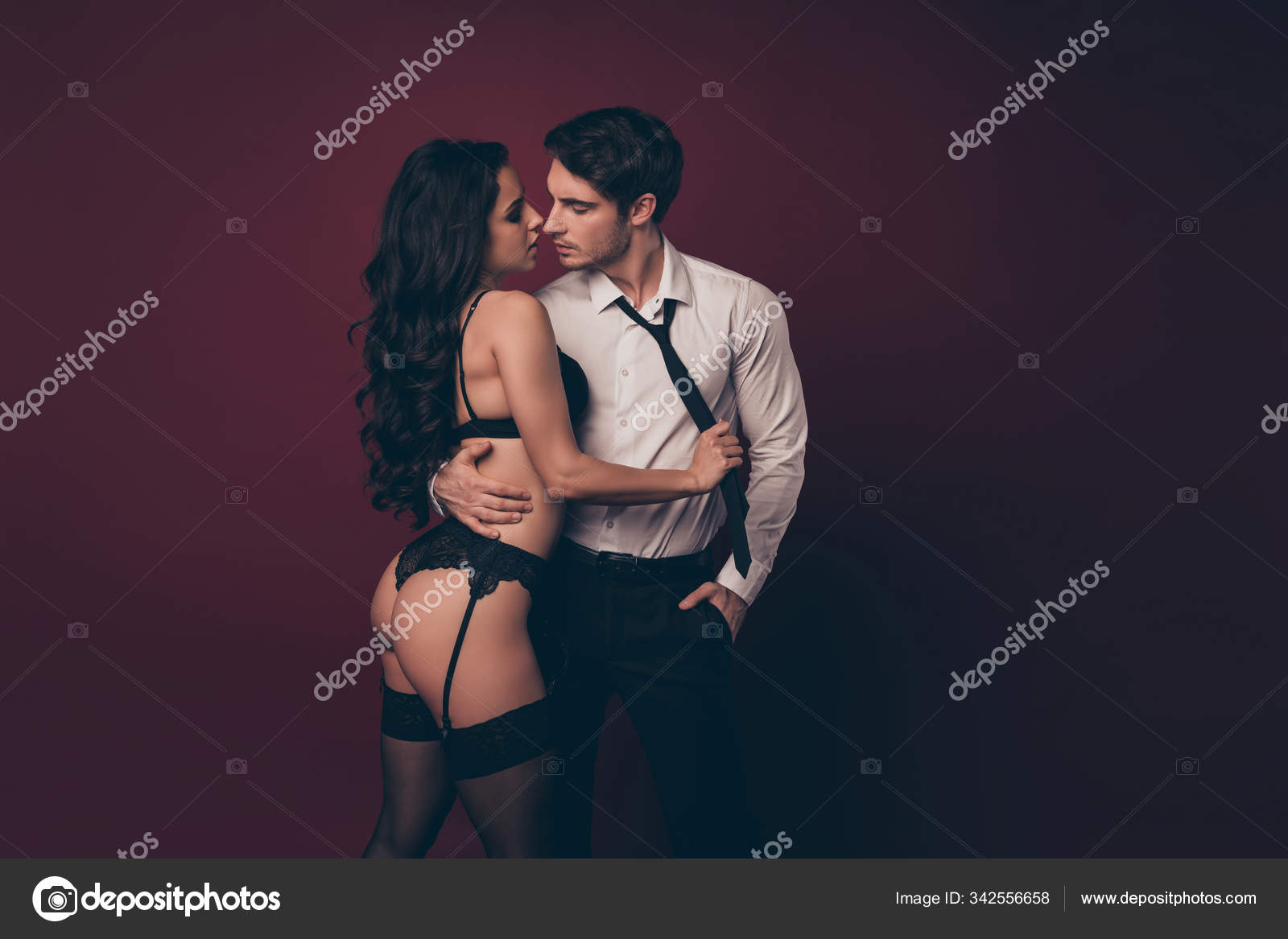 Profile photo of tender couple two people partners macho husband hold nude figure black bikini lady wife take off his suit pulling tie kiss pleasure isolated burgundy color background Stock Photo by © photo
