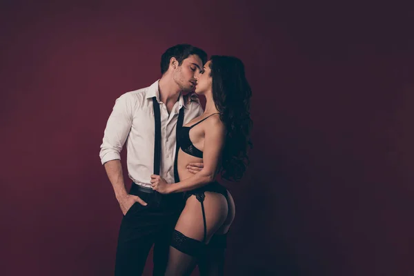 Profile photo of tender two people partners handsome husband hold nude figure bikini lady wife take off his suit pulling tie kissing xxx concept isolated maroon color background — 스톡 사진