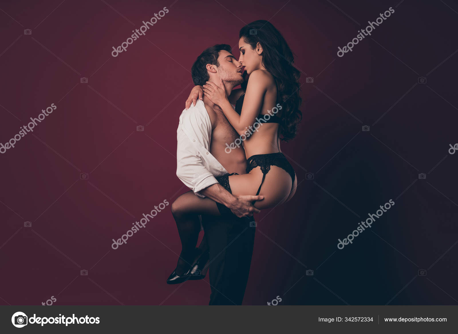 Profile photo of tenderness horny two people husband hold hands hips raise nude hot black bikini wife tempting kissing virile body strong arms isolated burgundy color background Stock Photo by ©deagreez1 342572334
