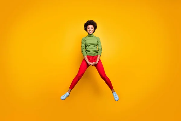 Full length body size view of her she nice attractive lovely cheerful wavy-haired girl jumping having fun fooling isolated over bright vivid shine vibrant yellow color background — стоковое фото