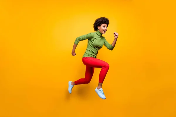 Full length body size view of her she nice attractive lovely girlish cheerful cheery wavy-haired girl jumping running activity isolated over bright vivid shine vibrant yellow color background — 图库照片
