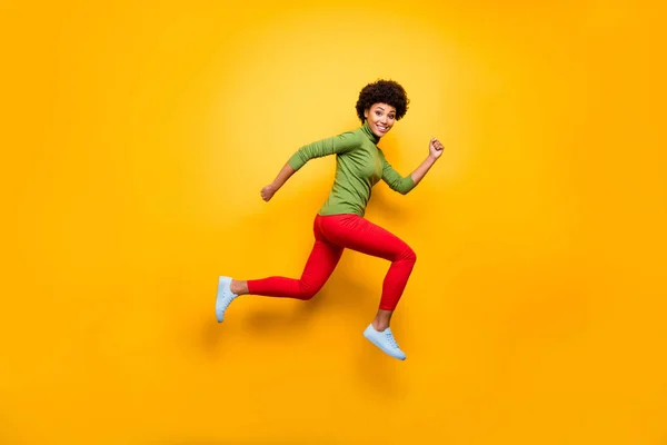 Full length body size view of her she nice attractive lovely cheerful cheery funky wavy-haired girl jumping running having fun isolated over bright vivid shine vibrant yellow color background — Stok fotoğraf