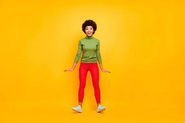 Full length body size photo of cheerful positive cute pretty nice woman in red pants white sneakers smile toothy falling back with wind blowing isolated vibrant color background — 图库照片