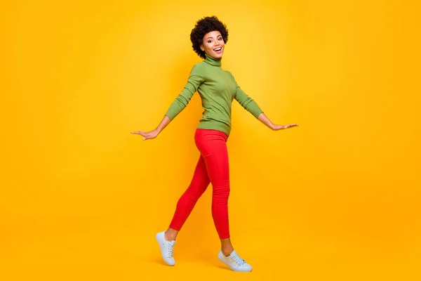 Full length body size view of her she nice attractive lovely teenage cheerful wavy-haired girl walking spending free spare time isolated over bright vivid shine vibrant yellow color background — 图库照片