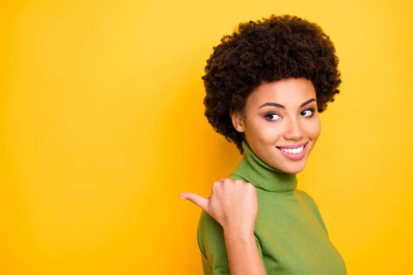 Close up turned photo of cheerful positive nice trendy woman pointing into empty space with her thumb smiling toothily isolated vibrant color background — 스톡 사진