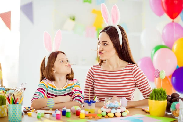 Close-up portrait of two nice attractive comic humorous playful cheerful girls small little pre-teen daughter wearing bunny ears holding pencil pout lips grimacing in white light interior room house — Stock Photo, Image