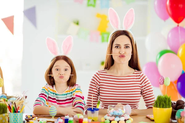 Close-up portrait of two nice attractive lovely comic childish cheerful cheery girls small little pre-teen daughter wearing bunny ears holding pencil pout lips in white light interior house — Stockfoto