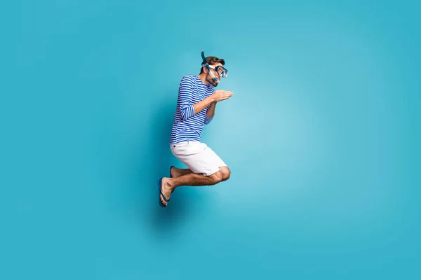 Full size profile photo of funky crazy guy tourist jump high swimming deep water mask tube diving wear striped sailor shirt vest shorts flip flops isolated blue color background — Stockfoto