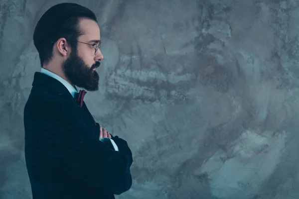 Close-up profile side view portrait of his he nice attractive representative serious bearded guy wearing velvet tux folded arms copy space isolated over gray concrete industrial wall background — 图库照片