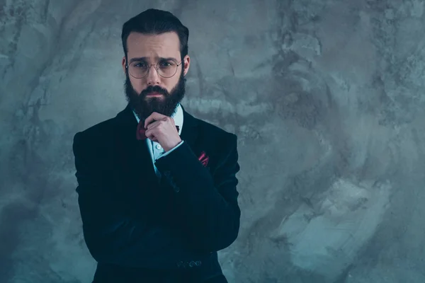 Portrait of his he nice attractive well-dressed sad bearded guy wearing tuxedo thinking isolated over gray concrete industrial wall background — ストック写真