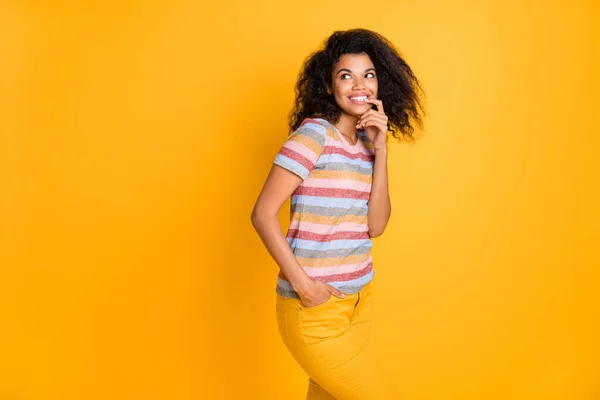 Portrait of her she nice attractive curious creative girlish cheerful cheery wavy-haired girl wearing striped tshirt biting nail thinking isolated on bright vivid shine vibrant yellow color background — Stock Photo, Image