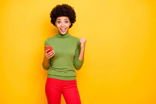Photo of cheerful positive cute pretty sweet woman smiling toothily expressing positive emotions on face in red trousers isolated vibrant color background — ストック写真