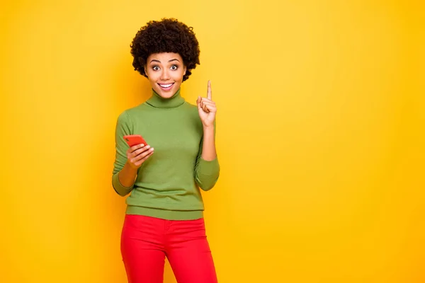 Photo of cheerful positive cute pretty girlfriend pointing up near empty space forefinger in red pants coming up with creative idea isolated vivid color background — Stok fotoğraf