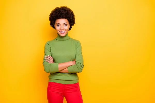 Photo of cheerful positive cute nice pretty charming woman with hands folded in red trousers smiling toothily near empty space isolated bright color yellow background — 图库照片