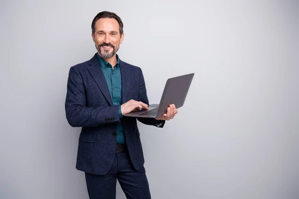 Photo of handsome business man holding notebook reading colleagues report email friendly good mood formalwear blazer shirt pants blue suit isolated grey color background
