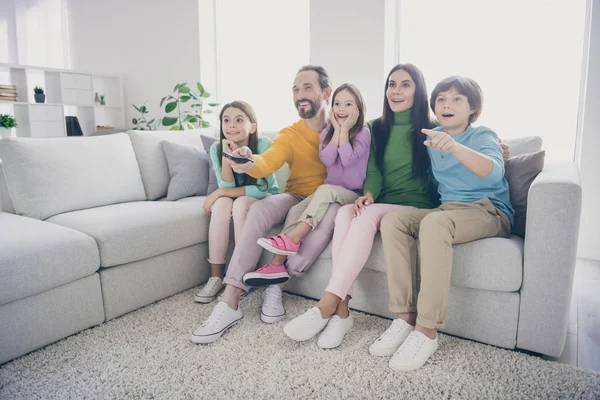 Dream harmony full family concept. Five people dad daddy mom mommy sit comfort couch watch cartoons little preteen schoolboy point index finger in room house
