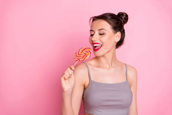 Portrait of positive girl hold lolipop want eat bite close eyes feel content wear casual style outfit isolated over pink color background — Stock Photo, Image