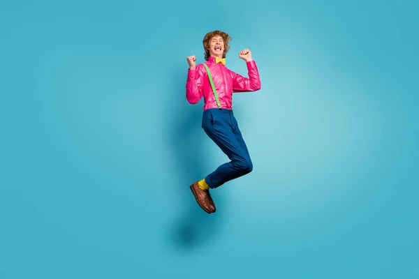 Full size photo of delighted crazy girl win discount lottery enjoy rejoice raise fists scream yeah wear pink pants trousers footwear isolated over blue color background — 스톡 사진