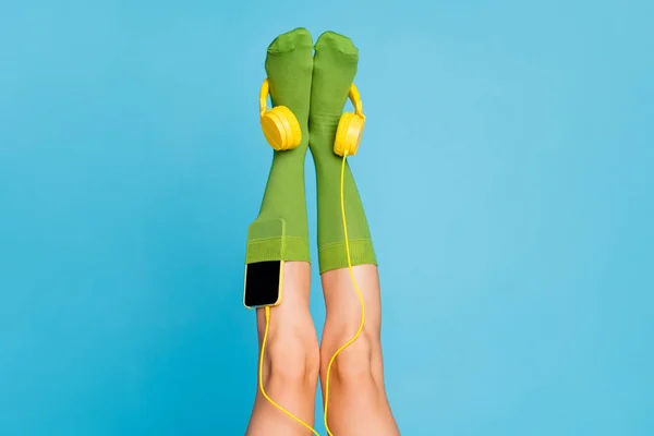 Cropped view of nice attractive lovely long legs wearing cozy comfortable mint green brandy socks with mp3 player put isolated over bright vivid shine vibrant blue color background — Stock Photo, Image
