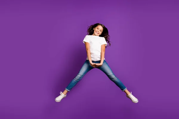 Повнометражний вигляд на її тіло вона приваблива прекрасна весела дівчина з хвилястим волоссям, яка стрибає, розважаючись ізольована на яскравому яскравому світлому фіолетовому бузковому фоні — стокове фото