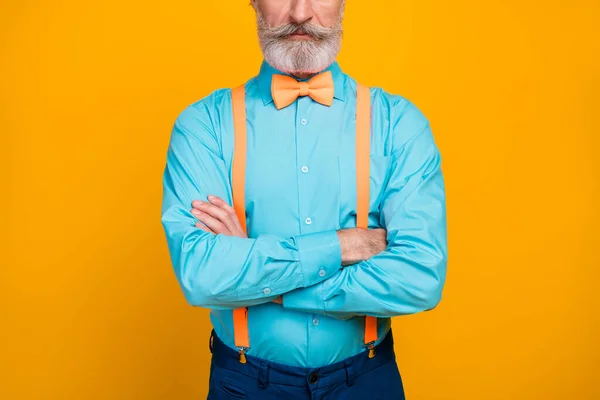 Cropped photo of handsome cool clothes grandpa hands crossed not smiling perfect groomed mustache beard wear blue shirt suspenders bow tie pants isolated yellow color background — Stock Photo, Image