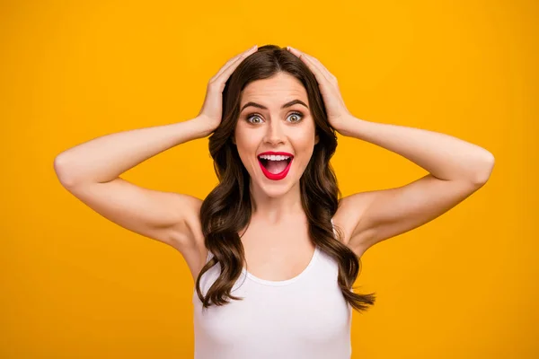 Closeup photo of beautiful pretty lady open mouth arms on head listen positive good mood surprised funky wear white tank-top isolated bright yellow color background — 스톡 사진