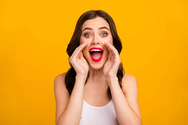 Closeup photo of beautiful pretty lady hands near mouth share secret information people crowd yelling empty space wear white tank-top isolated bright yellow color background — Stock Fotó