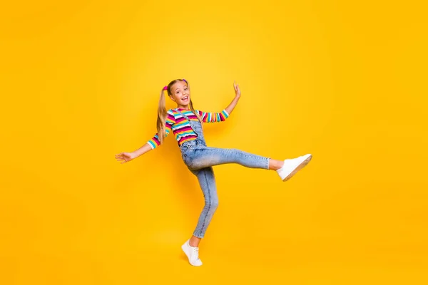 Full length photo of candid funny kid enjoy spring autumn rest relax holidays raise her legs up wear casual style pullover footwear isolated over shine color background — Stok fotoğraf